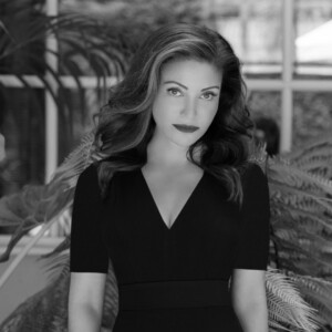 A headshot of a woman in black and white.